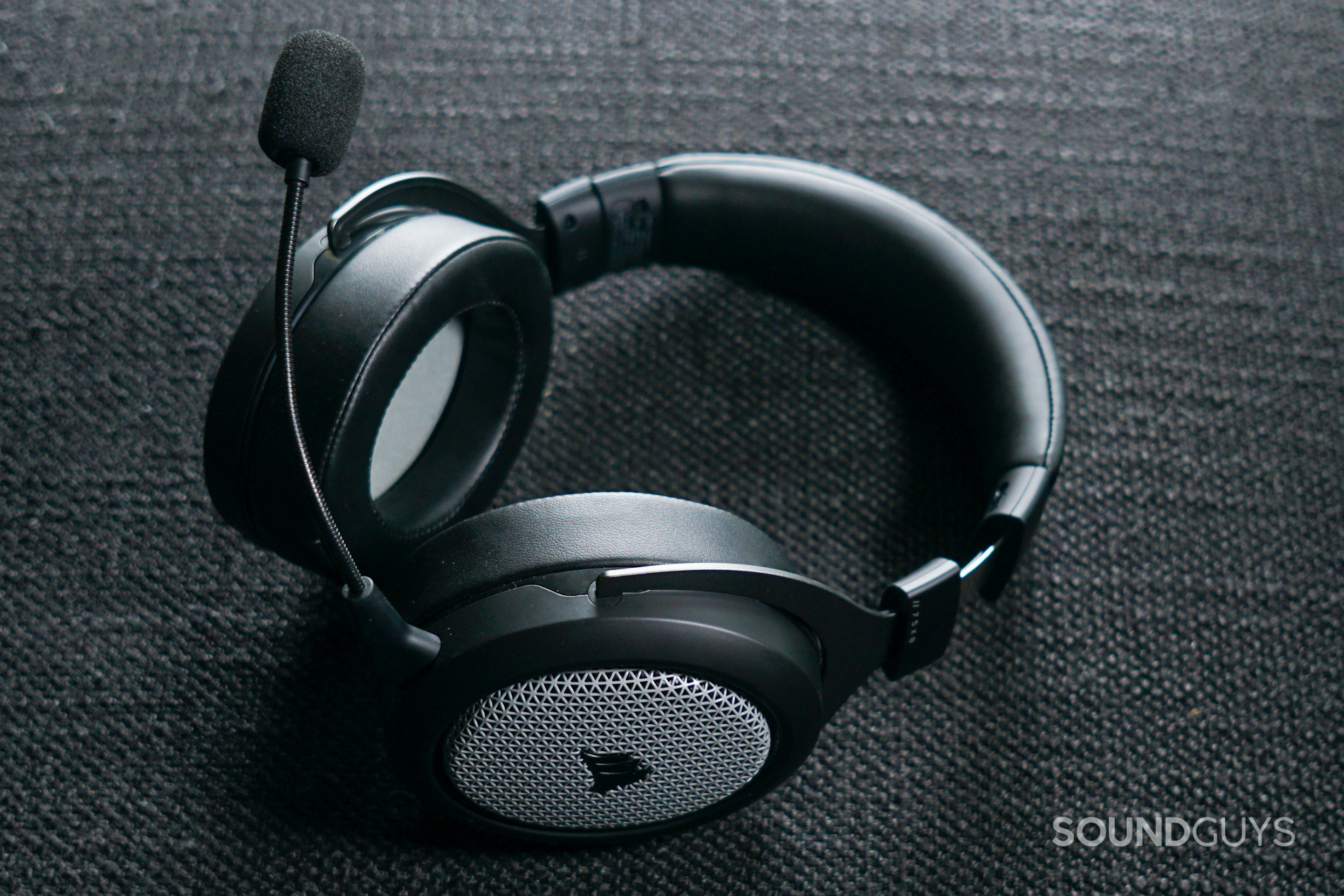 The Corsair HS75XB Wireless lays on a fabric surface with its mic attached