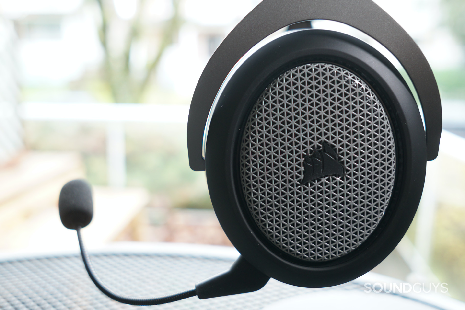 A close shot of the Corsair HS75 XB Wireless gaming headset's left headphone, with the mic attached.