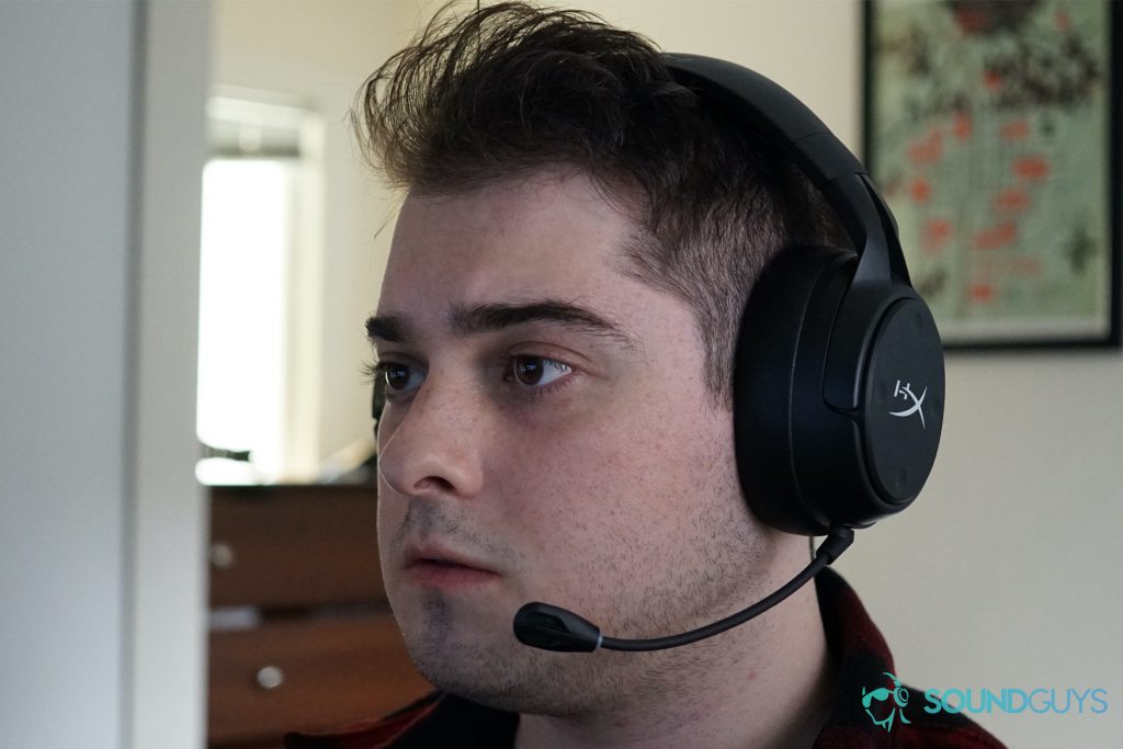 A man wears the HyperX Cloud Flight S sitting at a computer.