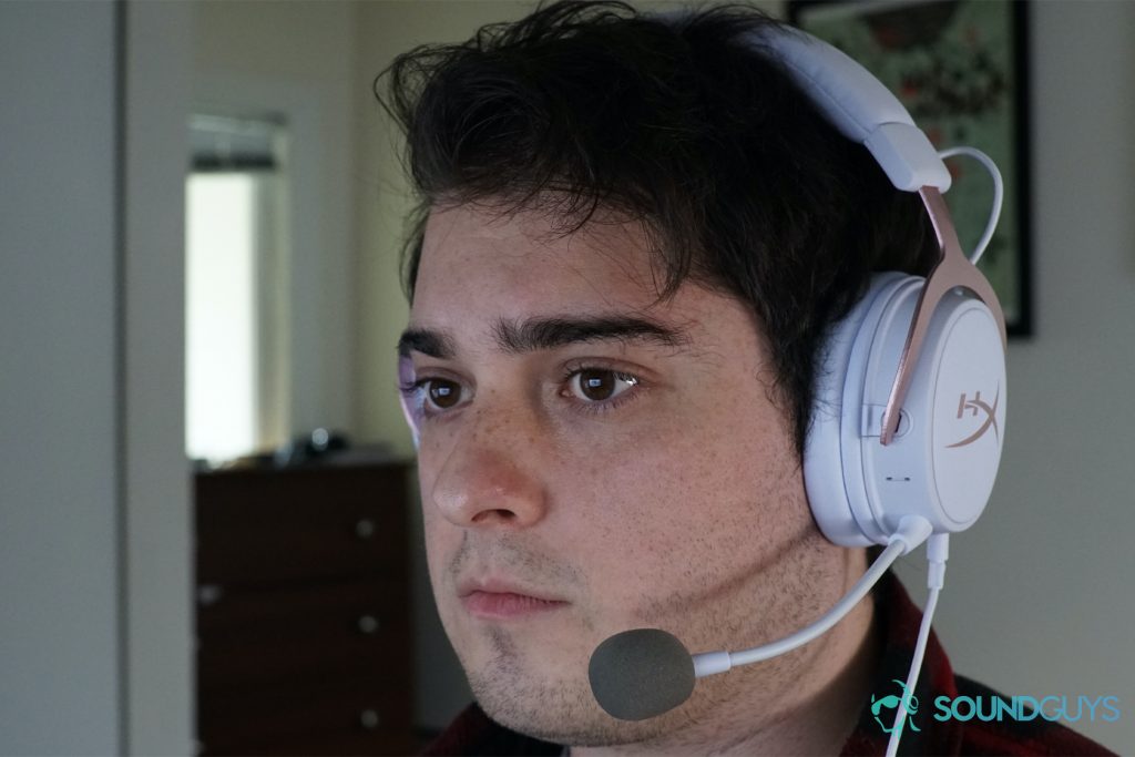 A man wearing the HyperX Cloud Mix, seated at a computer.
