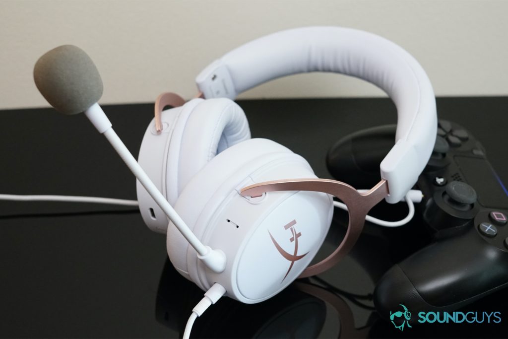 A photo of the HyperX Cloud Mix leaning on a Playstation 4 Dualshock controller, which is turned on.