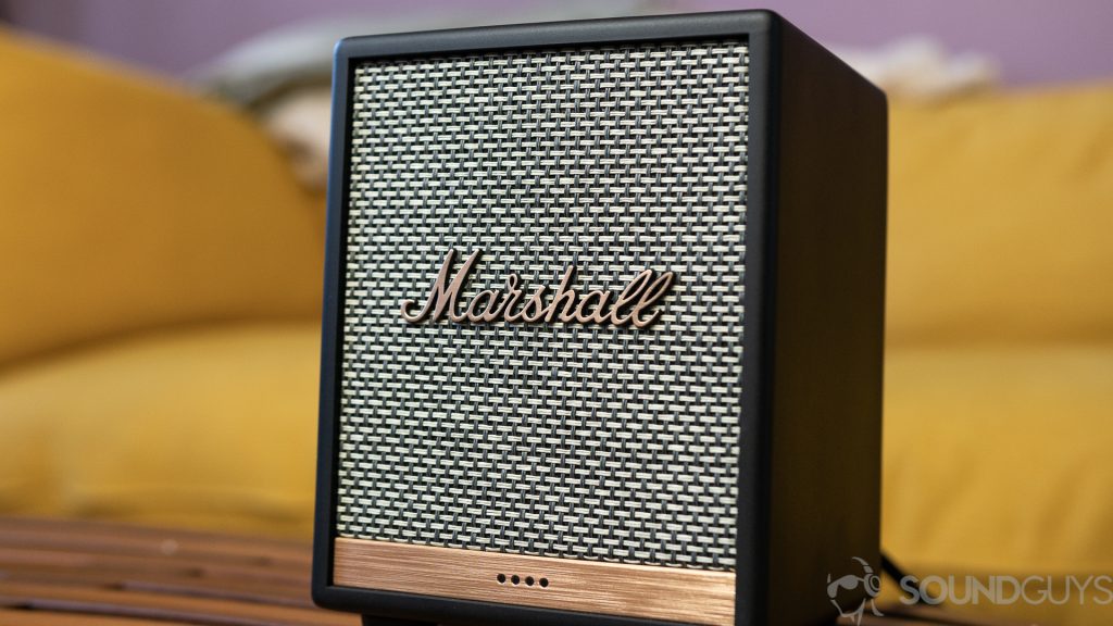 Marshall Uxbridge Voice speaker on top of coffee table with yellow couch in the background