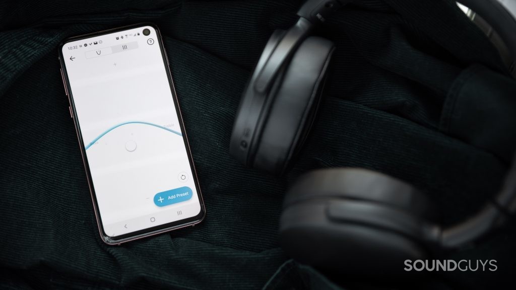 The Sennheiser HD 350BT Bluetooth headphones folded next to a Samsung Galaxy S10e with the Sennheiser Smart Control app with the visual custom EQ module open.