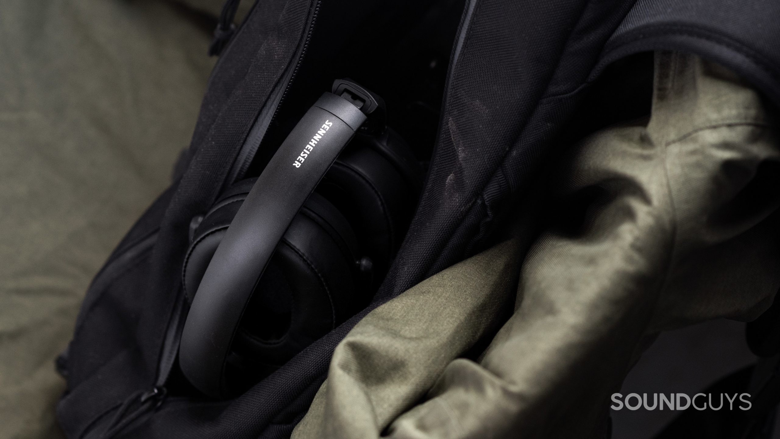 The Sennheiser HD 350BT Bluetooth headphones headband with the company logo facing upward, as the it sits in an open sling bag.