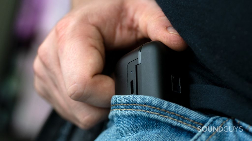 A photo of a man shoving the case of the Sennheiser CX 400BT into a pocket.