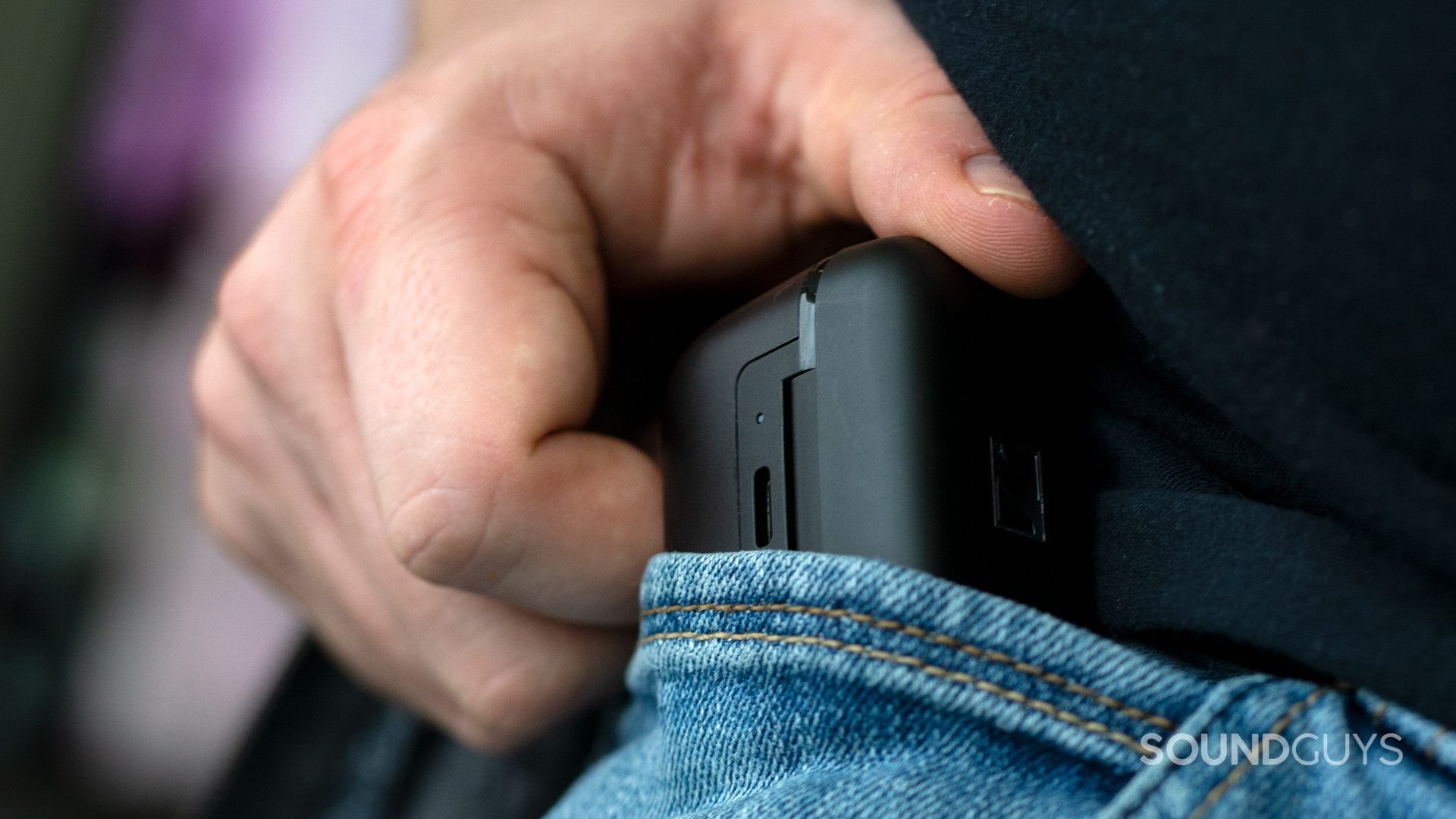 sennheiser-cx-400bt-case-pocket A photo of a man shoving the case of the Sennheiser CX 400BT into a pocket.