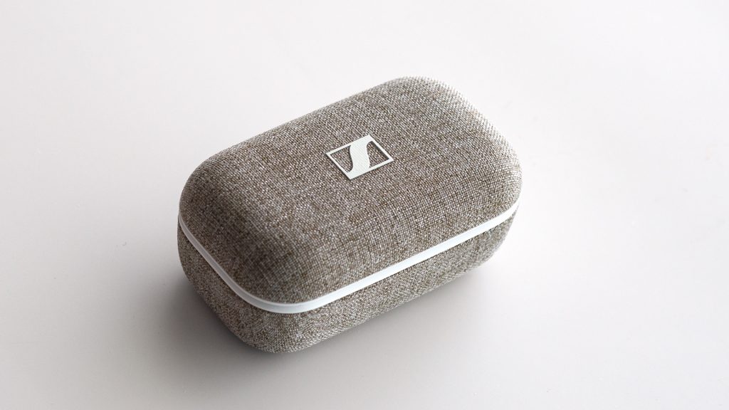 The Sennheiser MOMENTUM True Wireless 2's case, on a white table.