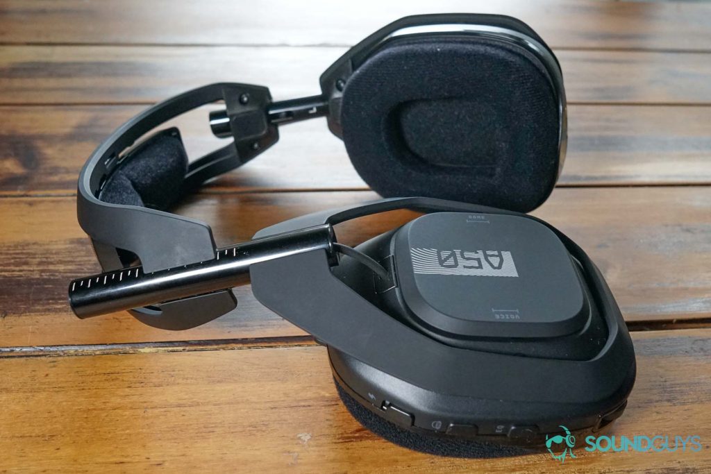 The Astro A50 Wireless lays on a wooden table.