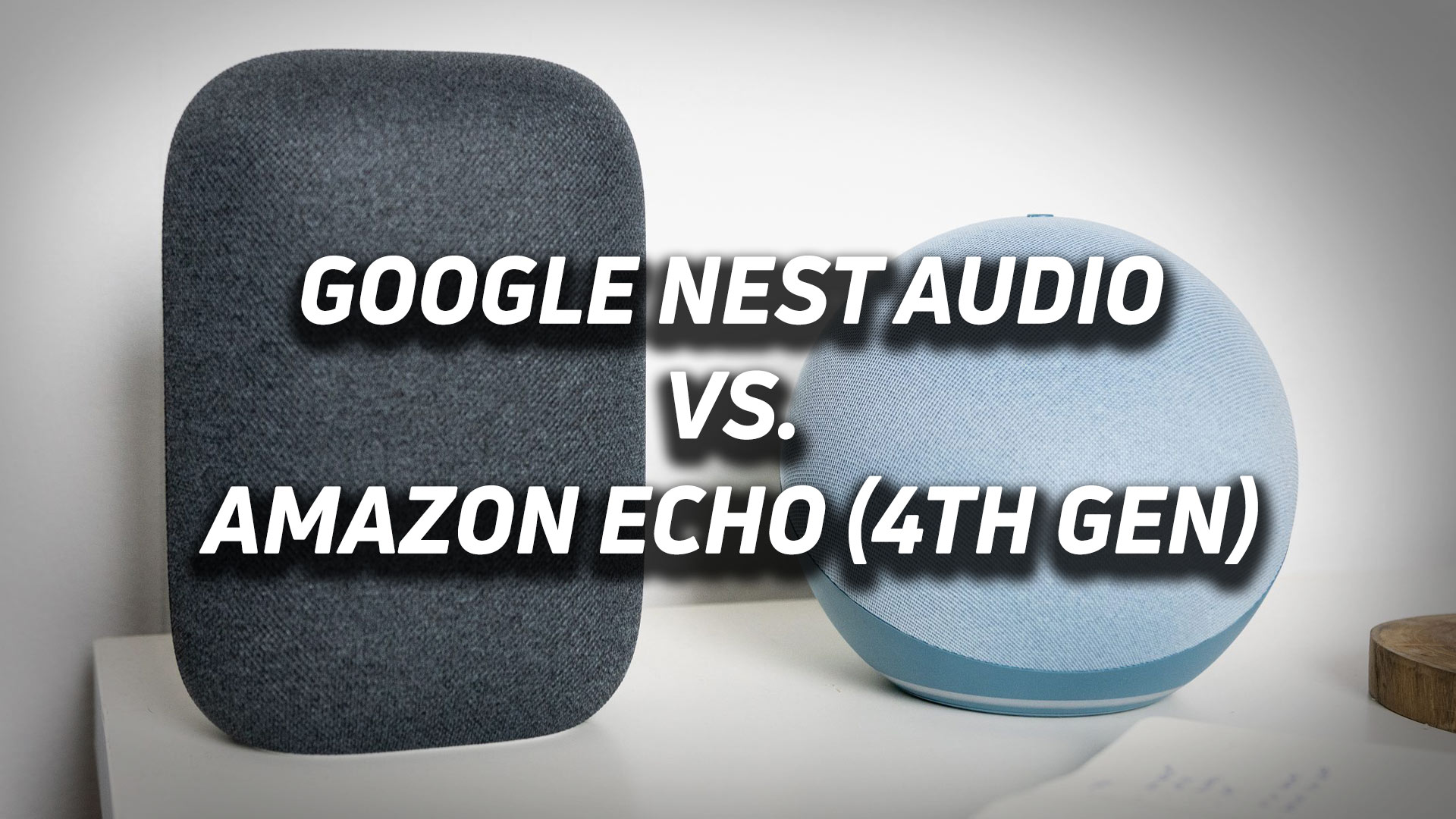 Amazon Echo 4th gen next to Google Nest Audio and a notebook on a white desk with versus text overlaid atop the image.