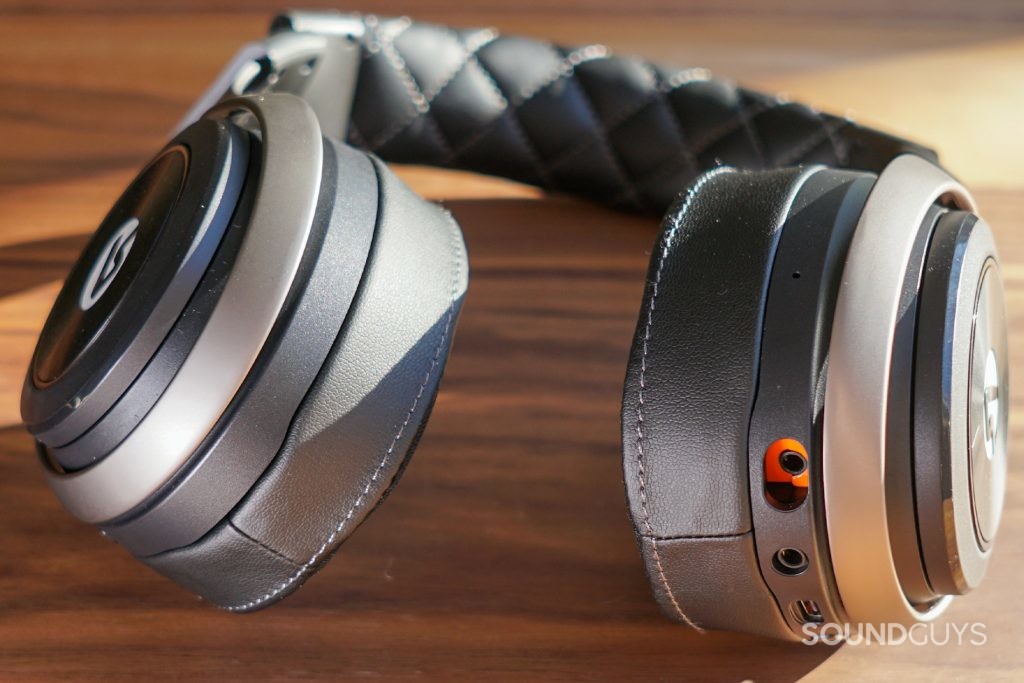 The LucidSound LS50X lays on a wooden table with its ports showing.