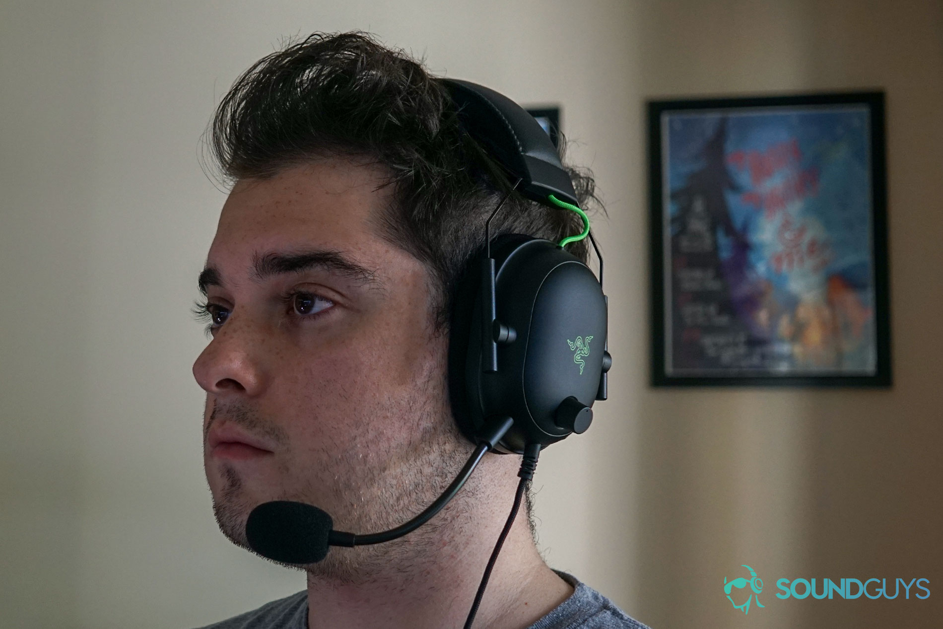 A man wears the Razer BlackShark V2 gaming headset while sitting at a PC