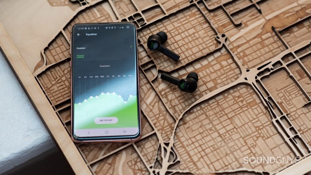 The Razer Hammerhead True Wireless Android app open on a Samsung Galaxy S10e smartphone next to the Razer Hammerhead True Wireless Pro earbuds.