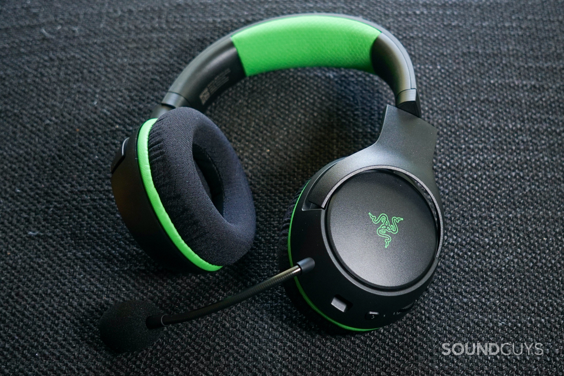 The Razer Kaira Wireless lays on a fabric surface.