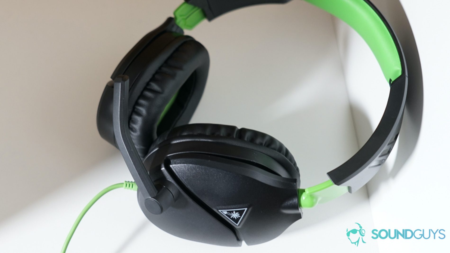 The Turtle Beach Recon 70 gaming headset on an off-white surface.