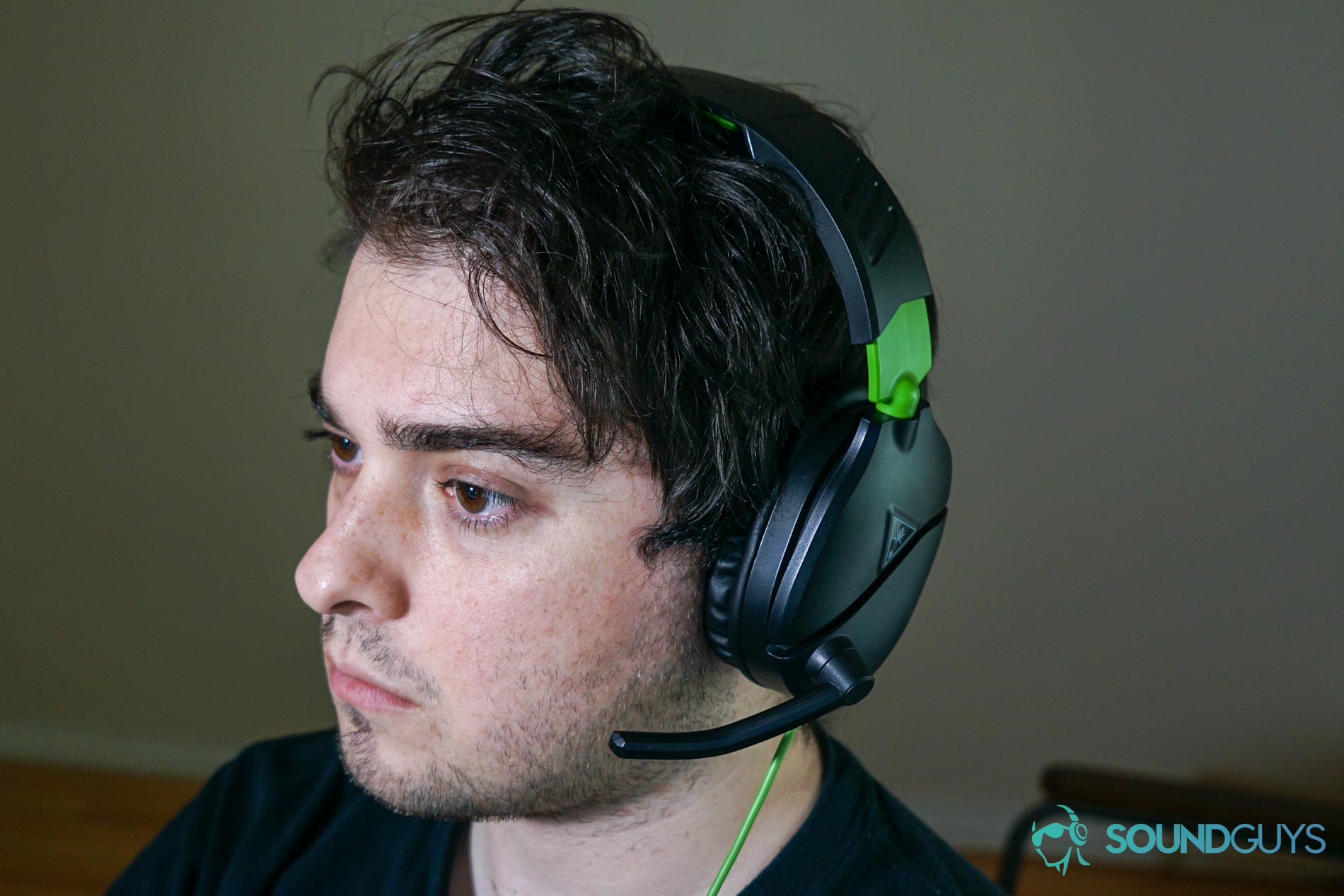 A man wears The Turtle Beach Recon 70 gaming headset sitting at a PC.