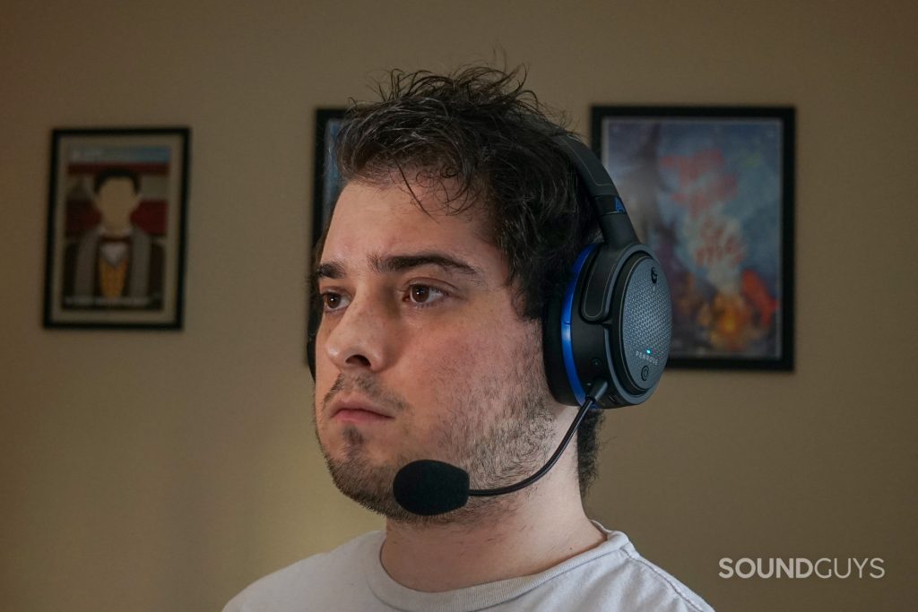 A man wears the Audeze Penrose sitting at a desk.
