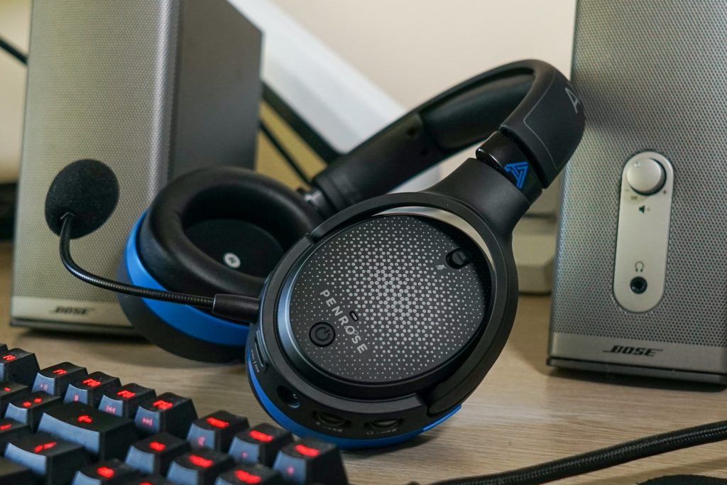 The Audeze Penrose sits on a PC in between Bose companion speakers, and in front of a Logitech G413 Carbon mechanical gaming keyboard