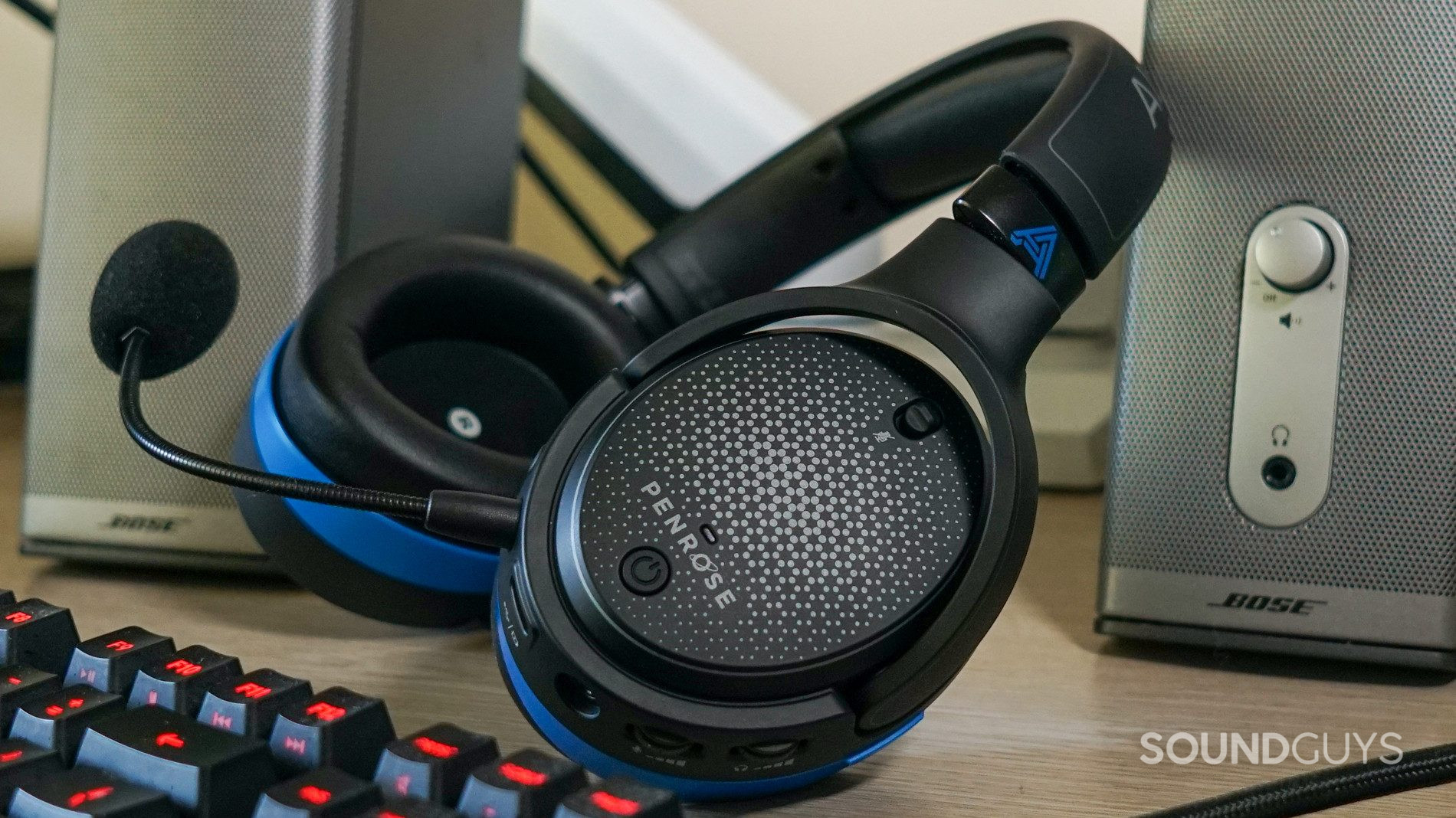 The Audeze Penrose sits on a PC in between Bose companion speakers, and in front of a Logitech G413 Carbon mechanical gaming keyboard