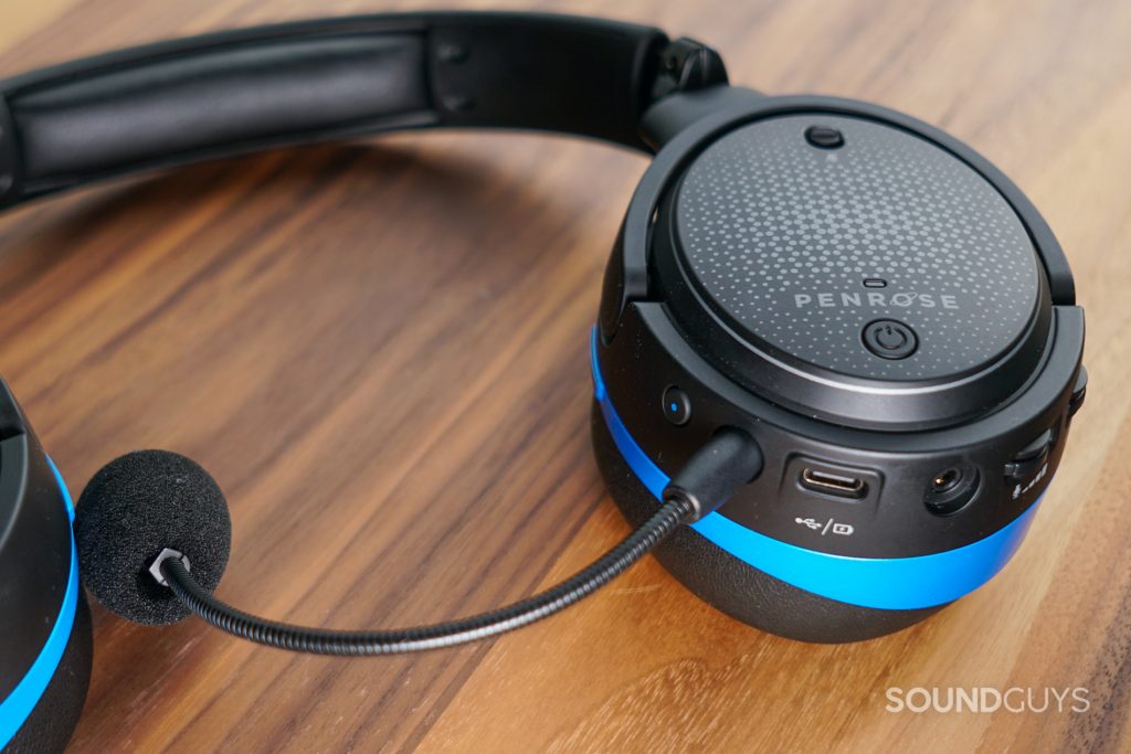 The Audeze Penrose lays flat on a wooden table with its ports in view.