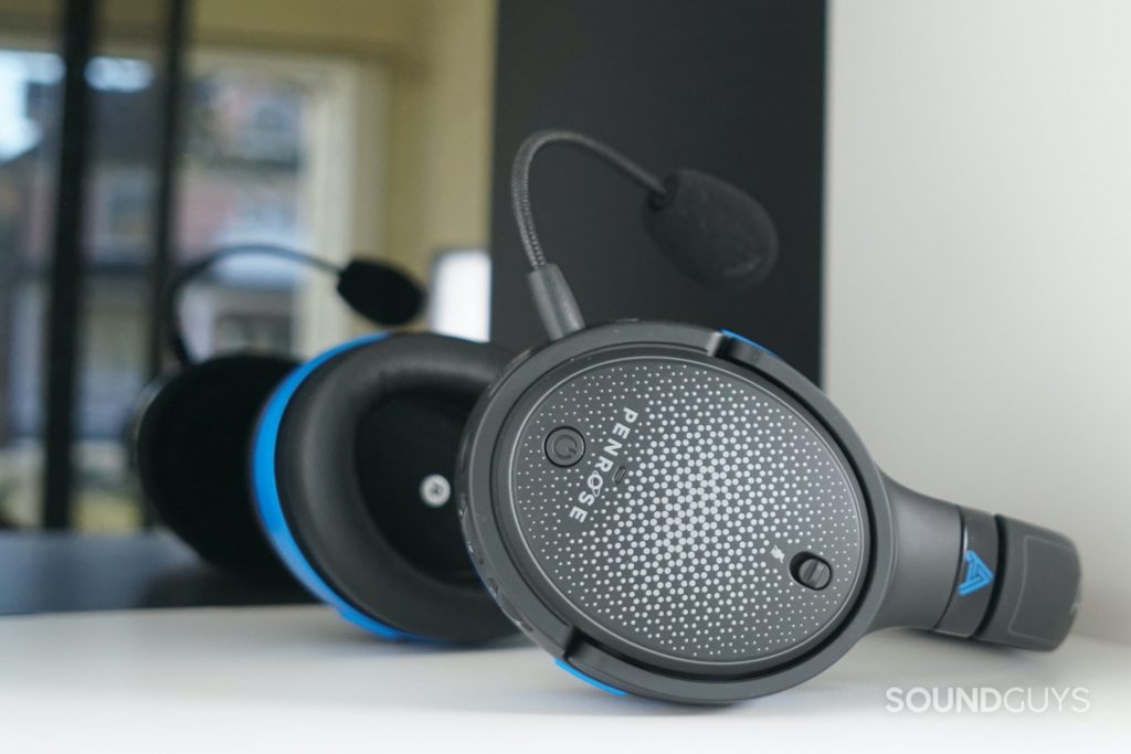 The Audeze Penrose lays on a white shelf in front of a reflective surface.
