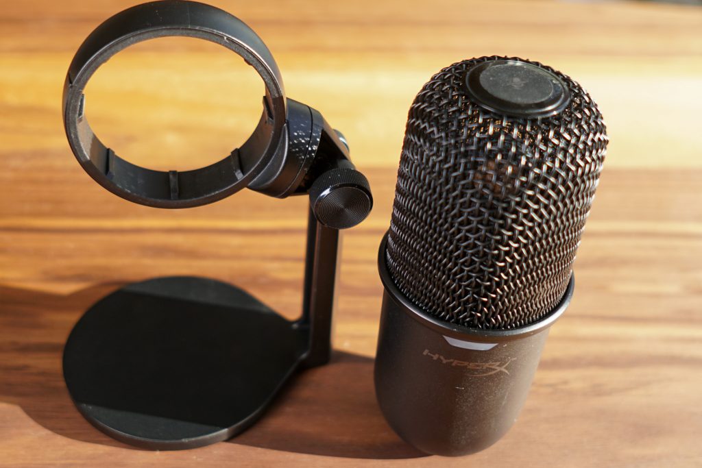 The HyperX Solocast stands next to its ring stand.