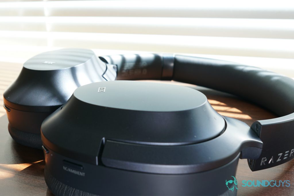 The Razer Opus sits on a wooden surface by some closed blinds.