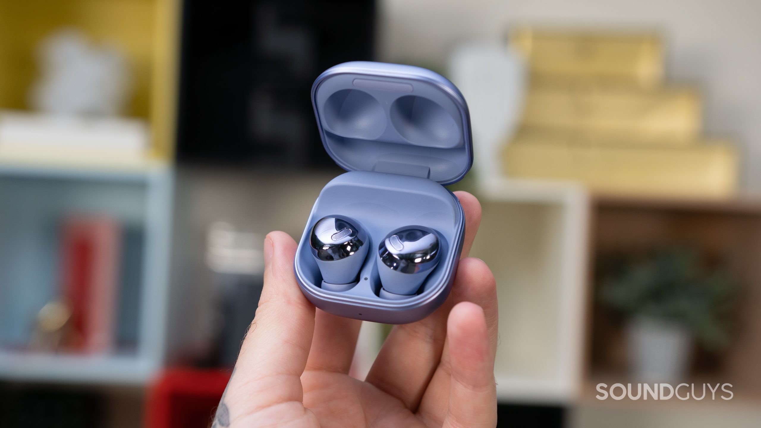 Man holding up the open charging case for the Samsung Galaxy Buds Pro.