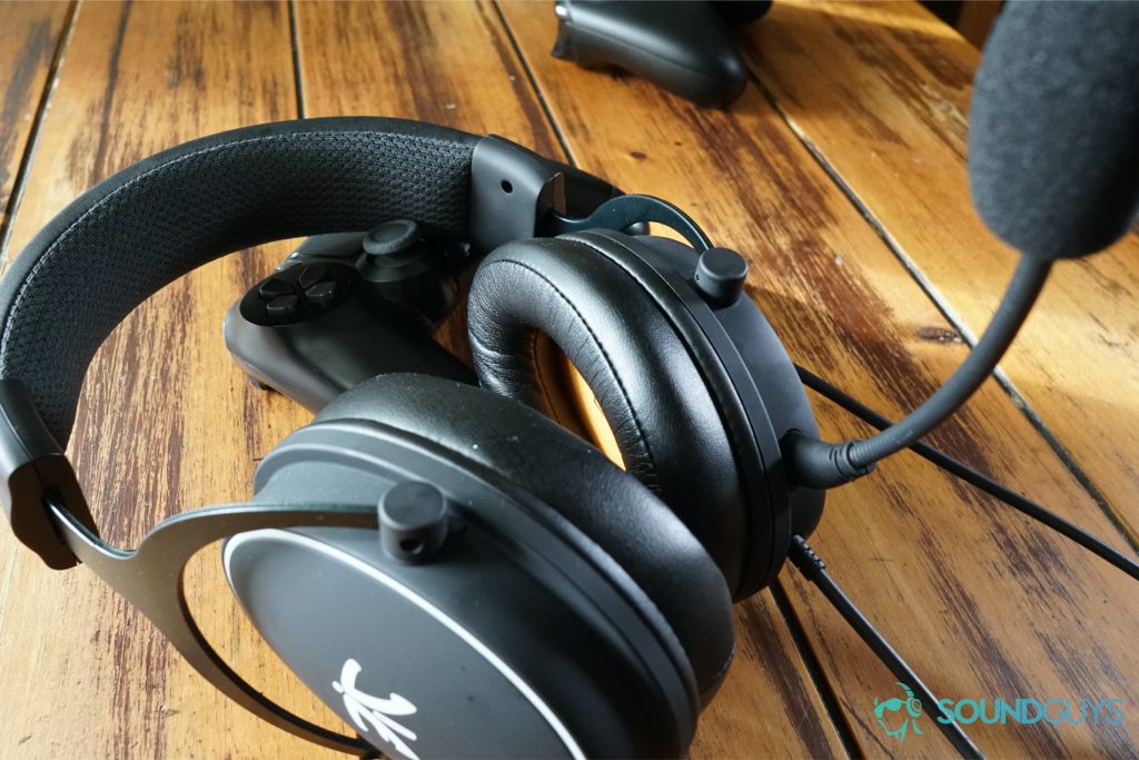 the fnatic react gaming headset leans on a Playstation 4 controller with an Xbox One controller in the background.