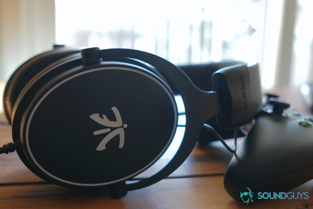 The fnatic react gaming headset leans on an Xbox One controller.