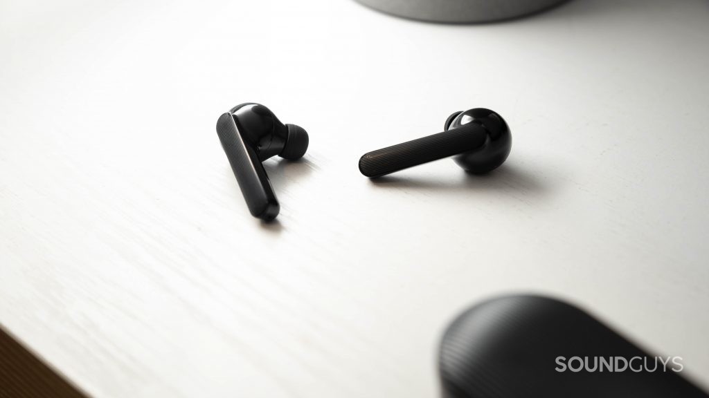 The Mobvoi Earbuds Gesture true wireless earbuds lie on a white surface.