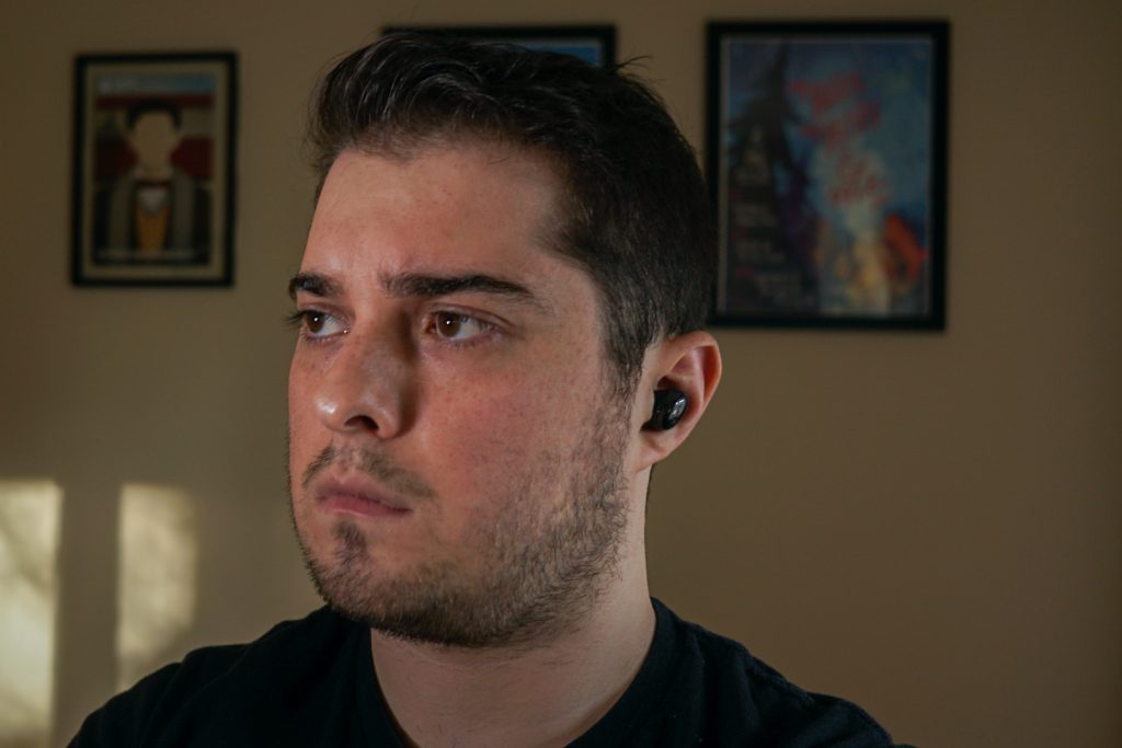 A man wears the Samsung Galaxy Buds Pro true wireless earbuds