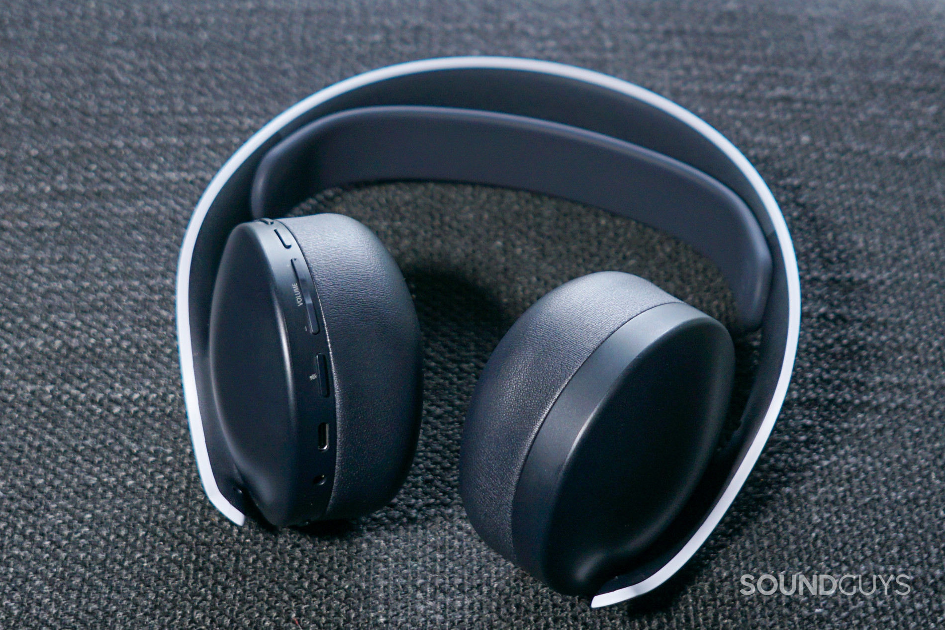 The Sony Pulse 3D Wireless Headset lays with its back facing up, showing it's on-ear controls.