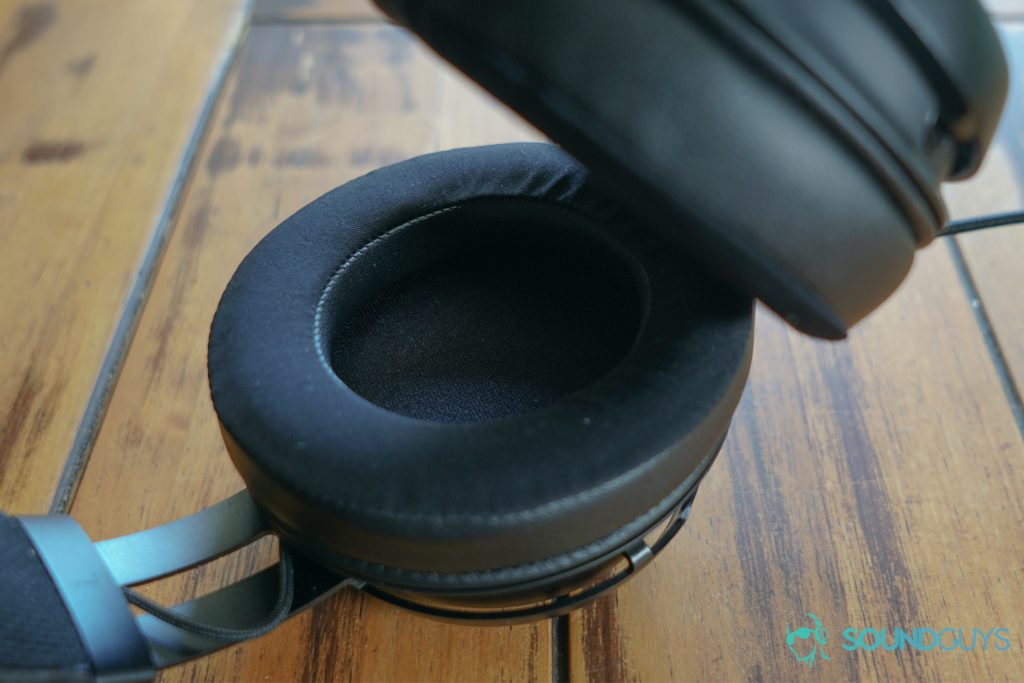 The Razer Kraken Ultimate lays on its side on a wooden table.