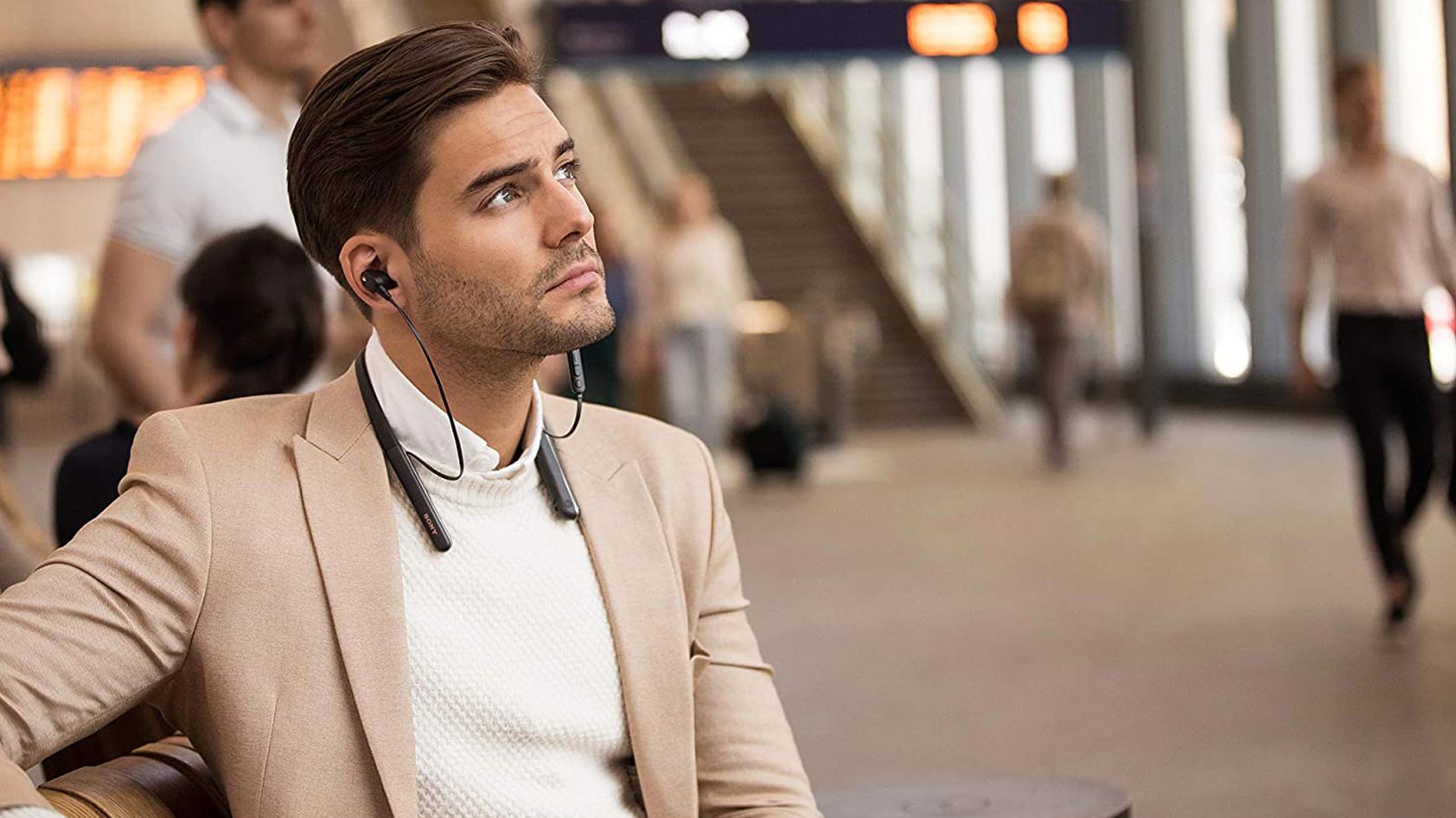 A man wears the Sony WI-1000XM2.