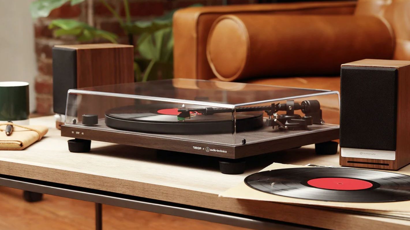 The Drop x Audio-Technica Carbon VTA in a living room next to a pair of Audioengine bookshelf speakers.