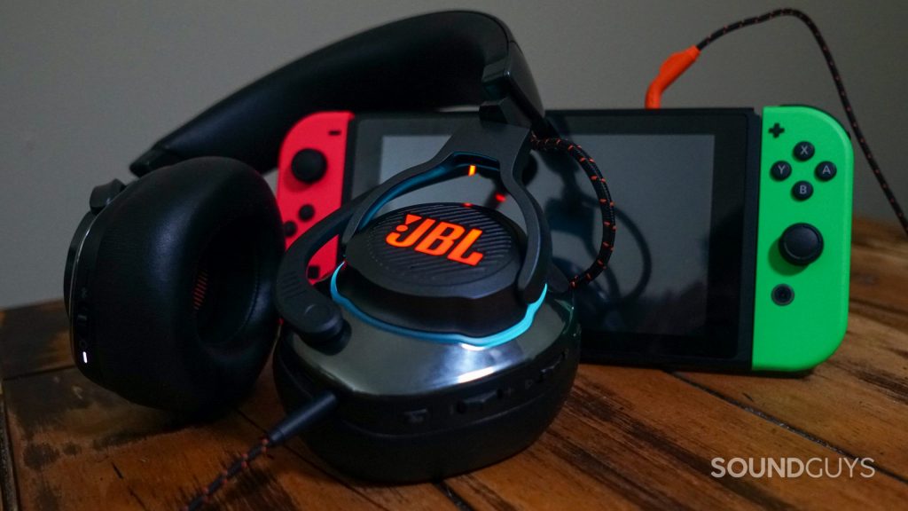 The JBL Quantum 800 leans on a Nintendo Switch, which it is plugged into.