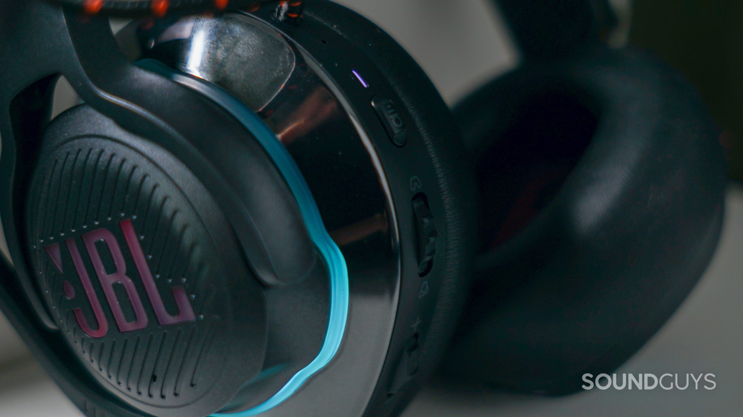 A close up shot of the JBL Quantum 800 gaming headset, showing the JBL logo and side controls.