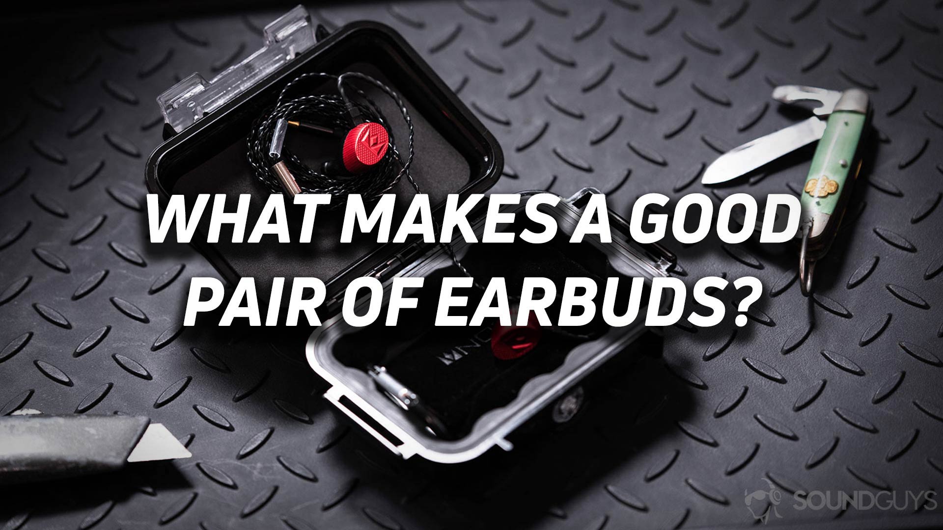 The Noble Kaiser 10 Massdrop IEMs in red inside a Pelican carrying case with the text "What makes a good pair of earbuds" overlaid.