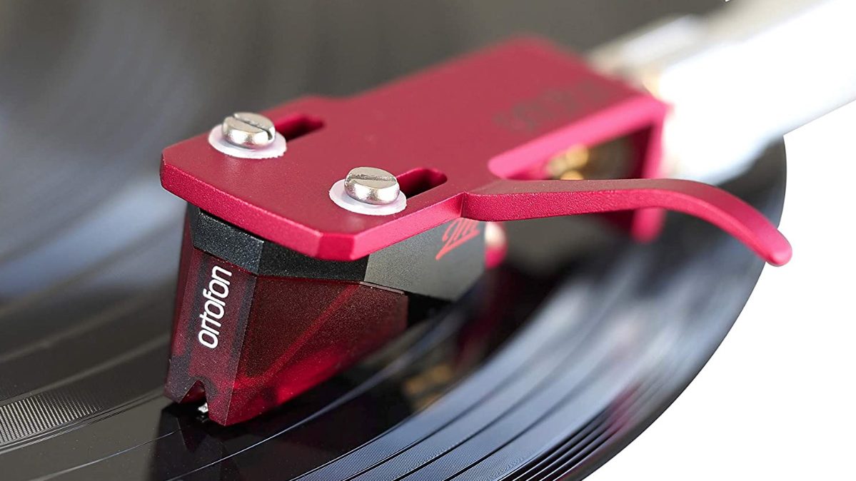 The Ortofon 2M red turntable cartridge on a spinning record.