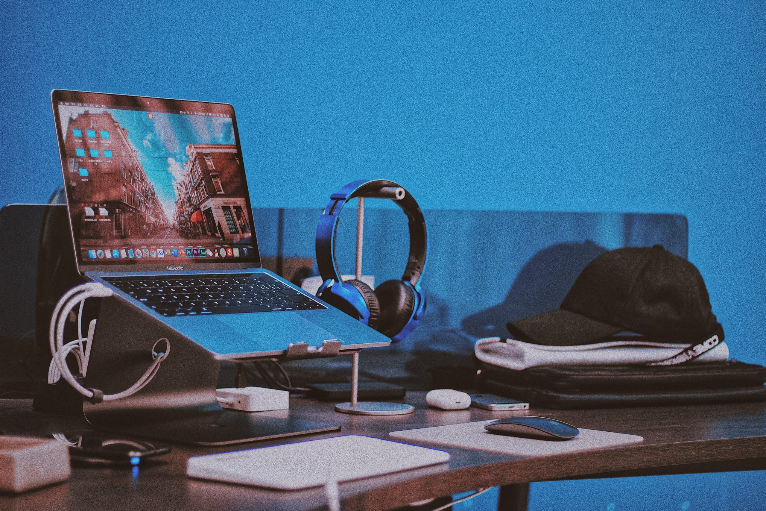 Macbook on a deskstand attached to audio peripherals and headphones