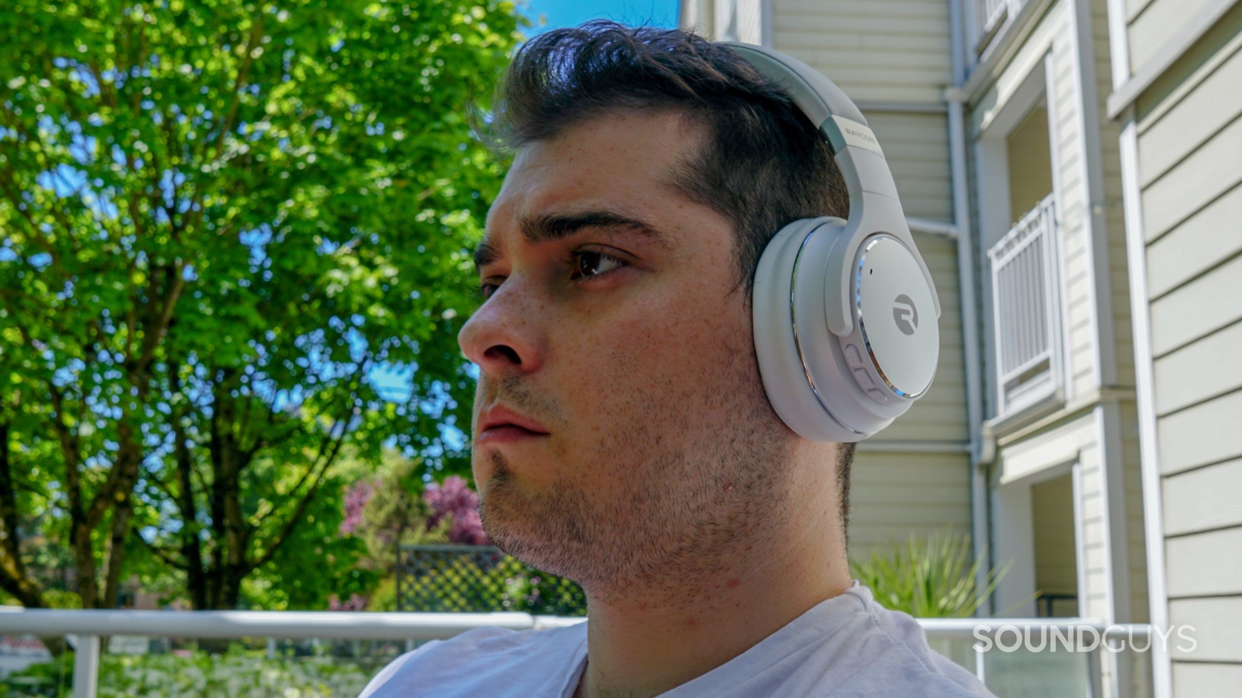 Raycon Everyday Headphones headshot A man wears the Raycon Everyday Headphones outside