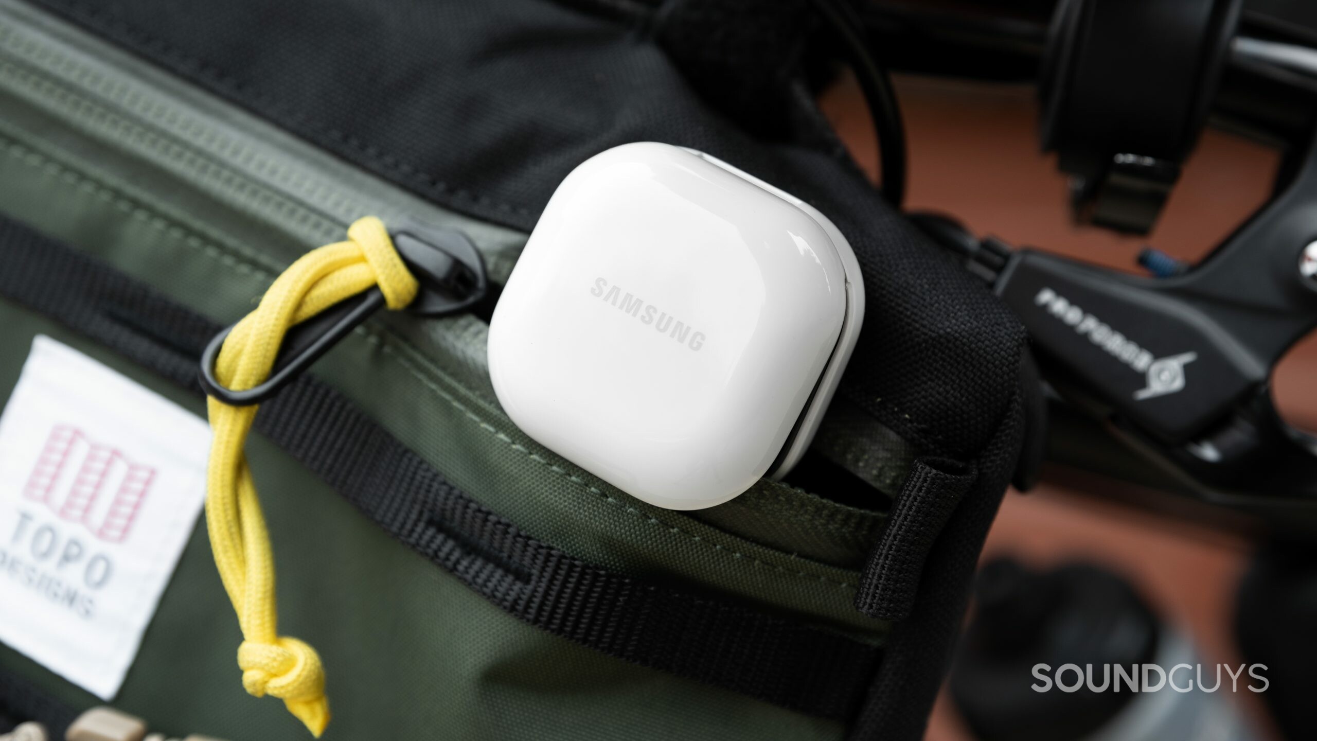 The Samsung Galaxy Buds 2 noise canceling true wireless earbuds case partway in a zippered bag.