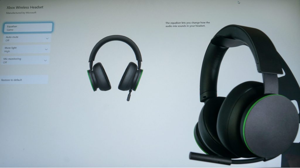 The Microsoft Xbox Wireless Headset sits on a stand in front of a Viewsonic monitor running the Xbox Accessories Windows desktop app.