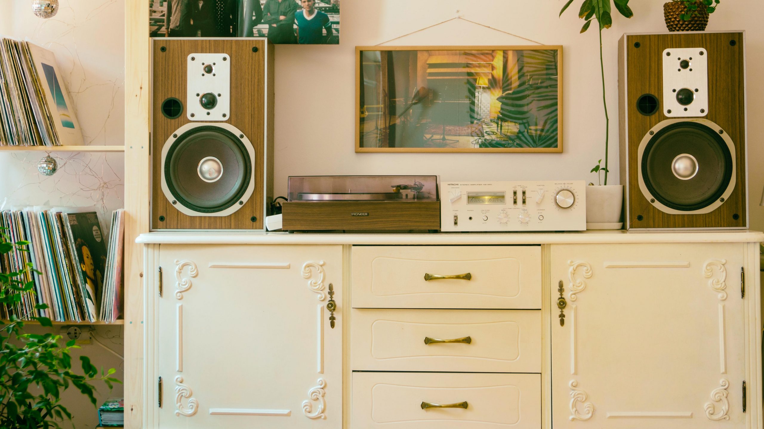 A pair of speakers flank a turntable in heavily decorated living room.