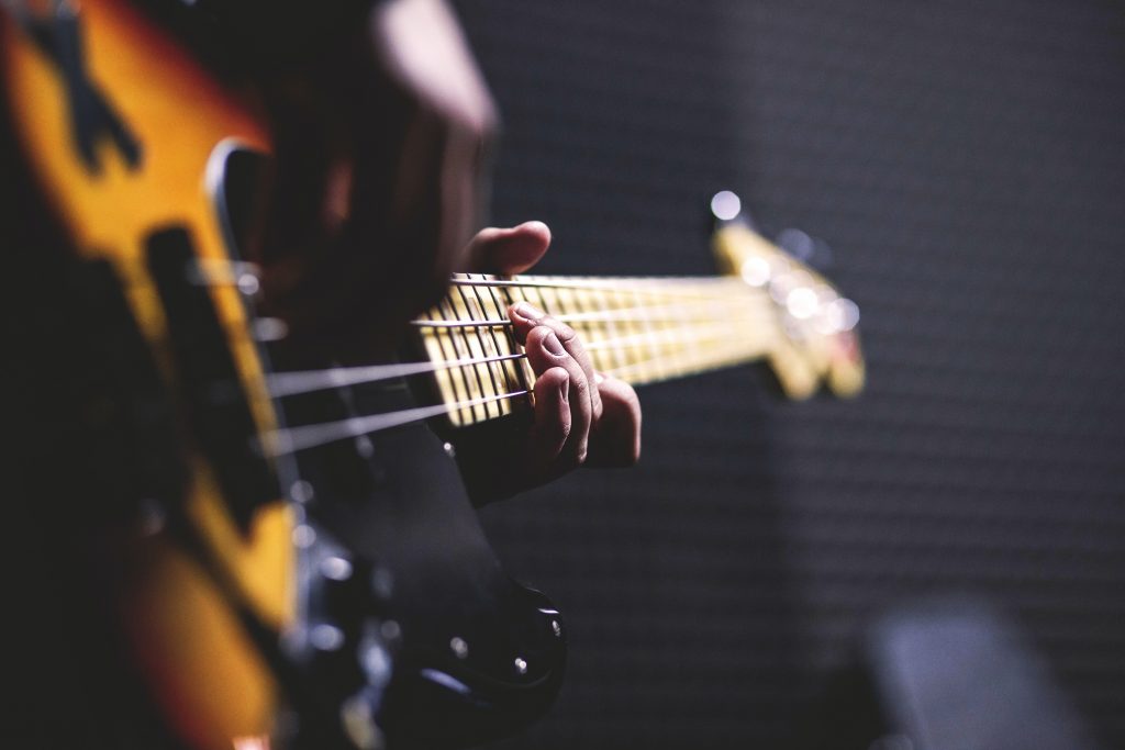 A bass guitar player playing a bass guitar.