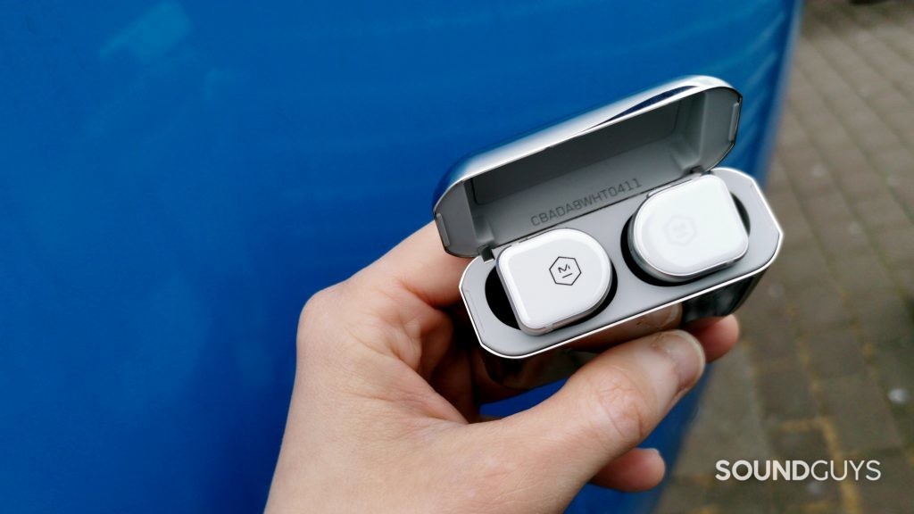 photo of hand holding master & dynamic mw08 earphone case to demonstrate scale
