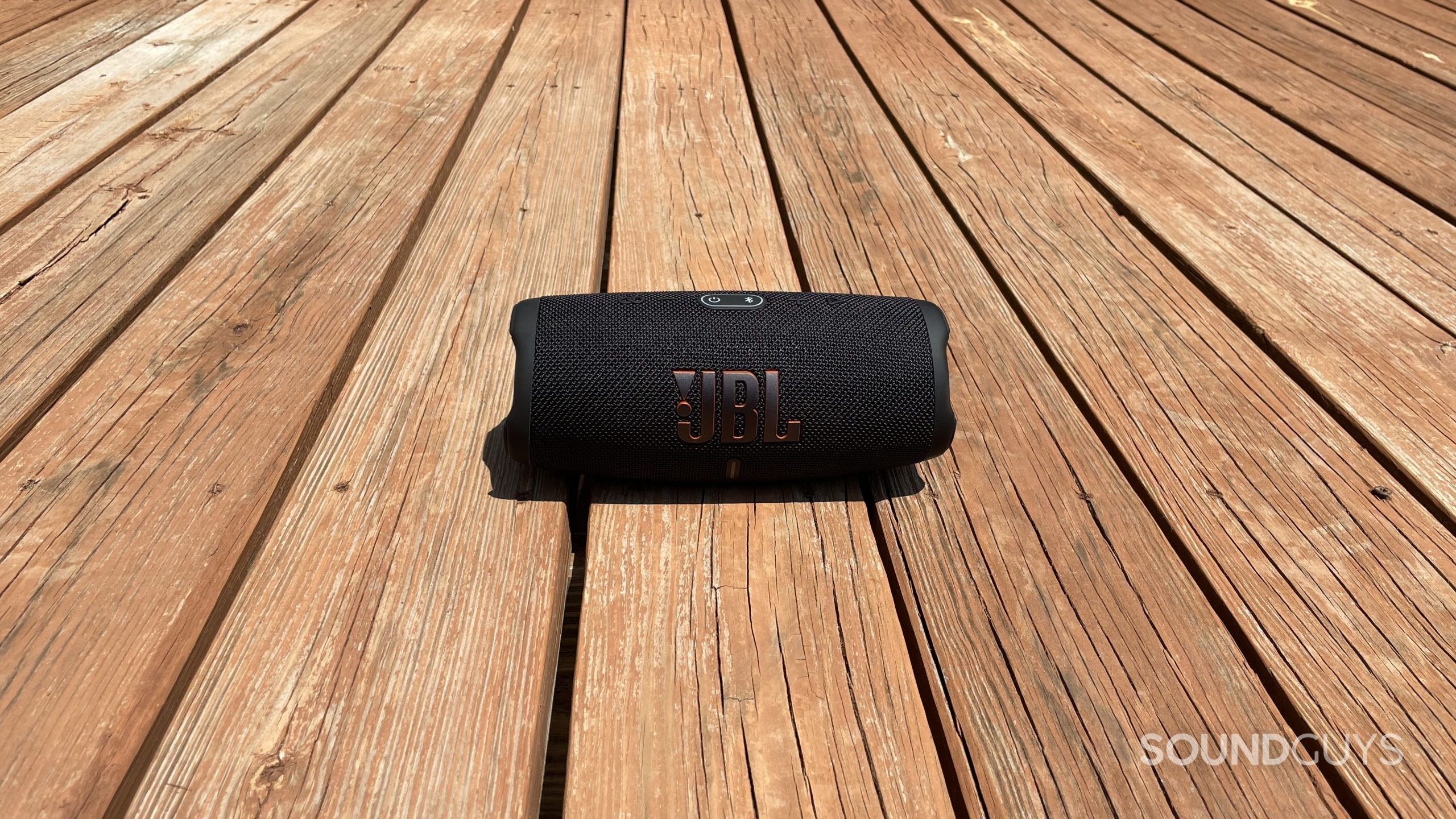 The JBL Charge 5 Bluetooth speaker on a balcony.