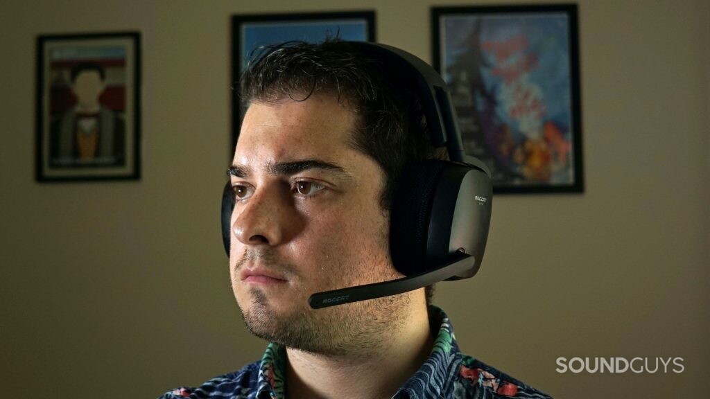 A man sits at a computer wearing the Roccat Syn Pro Air gaming headset.