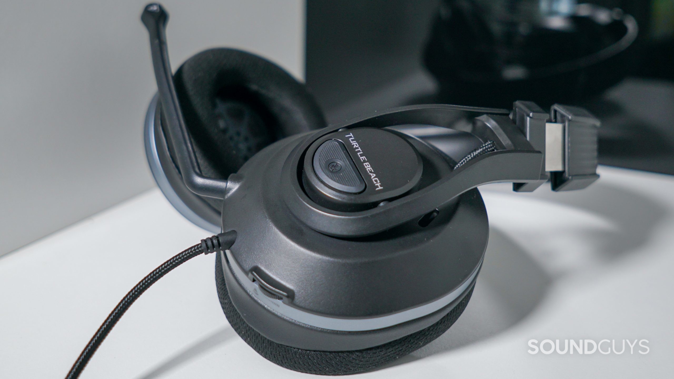 The Turtle Beach Recon 500 lays on a white shelf in front of a reflective black surface.