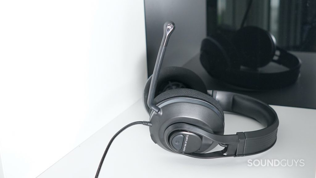 The Turtle Beach Recon 500 lays on a white shelf in front of a reflective black surface.